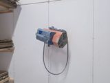 a picture of a room with a lot of shelves and a wall mounted light