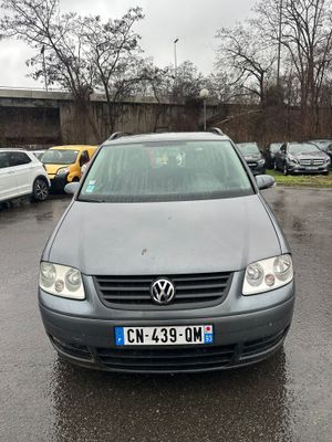 a car that is parked in a parking lot in the rain