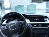 dashboard view of a car with a steering wheel and dashboard controls