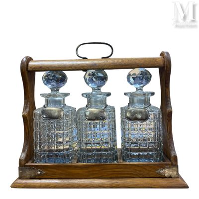 an image of a wooden and glass decanter with three bottles