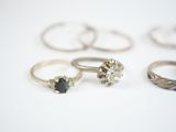 several different types of rings are arranged on a white surface
