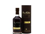 a bottle of whisky sitting next to a cardboard box on a white surface