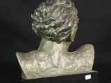 sculpture of a woman ' s head on a wooden base