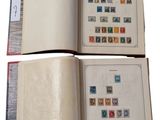 two pages of a book with stamps on them are open