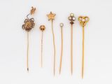 five gold and pearl hair pins, including a star, a heart, and a starfish