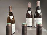 three bottles of wine sitting on top of a table next to each other