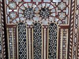an ornately decorated window in the middle of a building