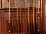 a lot of baseball bats that are hanging on the wall