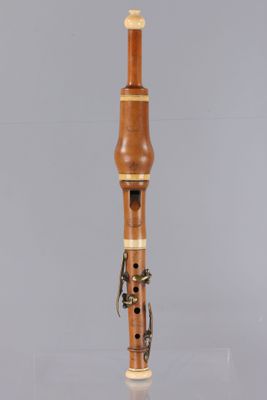 a close up of a musical instrument on a table with a gray background