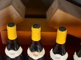 several bottles of wine are lined up on a table
