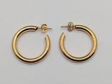 a pair of gold hoop earrings on a white background