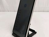 an iphone is sitting on a stand on a white surface