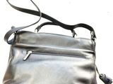 black leather purse with strap and zipper closure on white background
