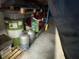a lot of gas bottles and cans on a pallet