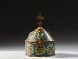 an ornately decorated box with a cross on top of it