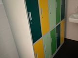 brightly colored lockers in a bathroom with a sink and a window