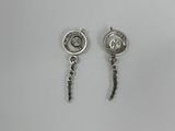 a pair of earrings on a white surface