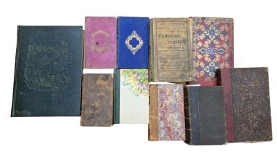 many old books that are stacked together on a white surface