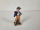 figurine of a boy with a backpack on a white background