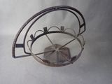 a metal basket with a fan inside of it on a table