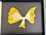 a picture of a picture of a yellow and white bow