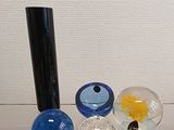 three glass vases sitting on top of a glass shelf