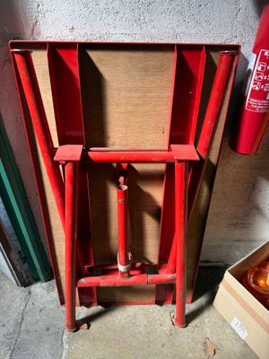 a red fire hydrant sitting next to a cardboard box
