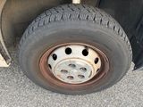 a tire with holes on the rim of a truck