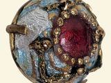 an image of a ring with a red stone in it
