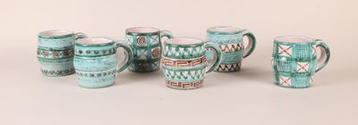 a group of cups and mugs that are sitting on a table