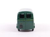 a green toy bus with a white roof on a white surface