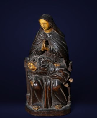 a statue of a woman holding a child in her lap