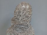 a stone statue of a man with a hat on