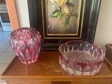 two vases sitting on a wooden table next to a painting
