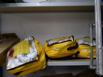 two bags of luggage sitting on a shelf next to a sink