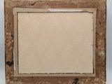 an old picture frame with a piece of paper in it
