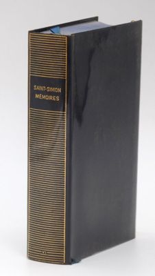 a black book with gold trim sitting on top of a white surface