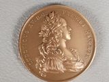 a close up of a coin on a white surface