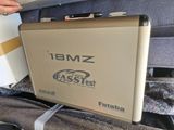 a laptop computer sitting on top of a suitcase