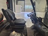 a picture of a golf cart parked in a garage