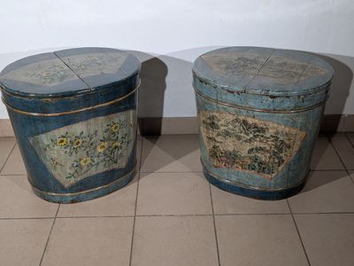 two blue tins sitting next to each other on a tiled floor