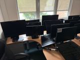 many computer screens on the desk in this office