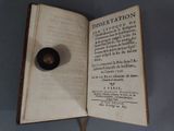 a book with a black object in it on a table