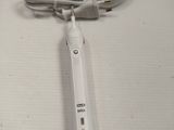 an image of a white electric toothbrush on a table