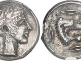 a close up of a silver coin with a head of a woman on it