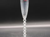 a clear glass with a red sticker on it