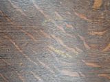 a close up view of a wooden table with scratches on it