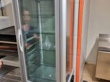 a woman standing in front of a refrigerator in a kitchen