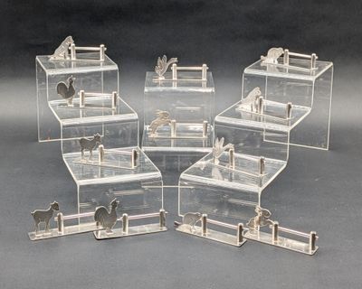 quatre boîtes transparentes représentant des chevaux, avec des chevaux à l'intérieur, posées sur une surface grise