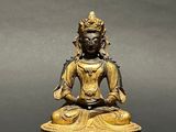 an image of a statue of a buddha sitting on a table